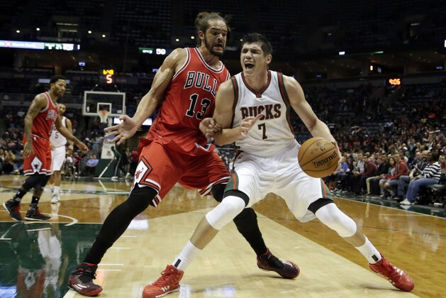 Milwaukee Bucks forward Ersan Ilyasova, right, goes up for a basket against Chicago Bulls center Joakim Noah, left, during the second half of a preseason NBA game Saturday, Oct. 11, 2014, in Milwaukee. (AP Photo/Darren Hauck)