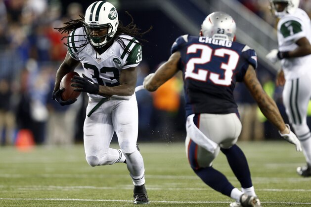 Oct 16, 2014; Foxborough, MA, USA.New York Jets running back Chris Ivory (33) runs with ball against New England Patriots strong safety Patrick Chung (23)l during the first half at Gillette Stadium. Mandatory Credit: Mark L. Baer-USA TODAY Sports