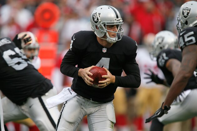 OAKLAND, CA - DECEMBER 07:  Derek Carr #4 of the Oakland Raiders hands off  in the second quarter against the San Francisco 49ers at O.co Coliseum on December 7, 2014 in Oakland, California.  (Photo by Brian Bahr/Getty Images)