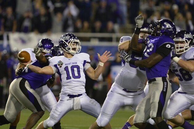 Dec 20, 2013; Salem, VA, USA; Mount Union Purple Raiders quarterback Kevin Burke (10) passes the ball as UW-Whitewater defensive lineman Kevon Clunis (92) pressures in the second quarter at Salem Stadium. Mandatory Credit: Bob Donnan-USA TODAY Sports