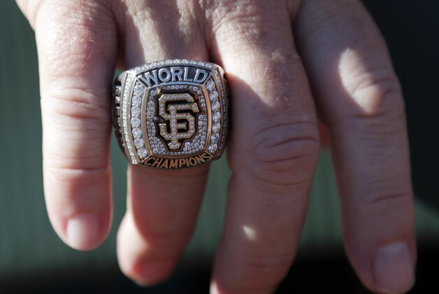 San Francisco Giants general manager Brian Sabean wears a World Series championship ring as the team works out on Saturday, Oct. 18, 2014, in San Francisco.  The Giants are scheduled to play the Kansas City Royals in Game 1 of baseball's World Series on Tuesday, Oct. 21, in Kansas City. (AP Photo/Marcio Jose Sanchez)