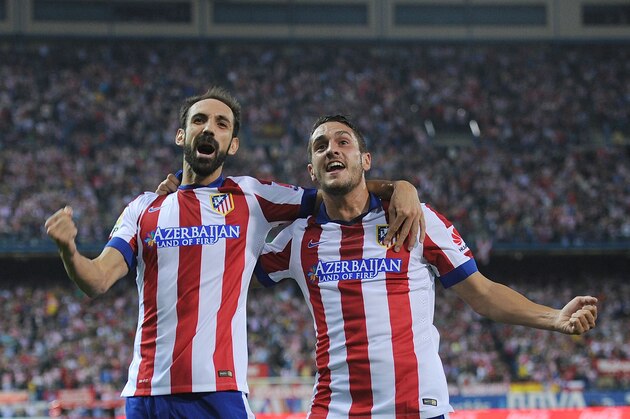 MADRID, SPAIN - SEPTEMBER 27:  Koke (R) of Club Atletico de Madrid celebrates with Juanfran after scoring his team's opening goal during the La Liga match between Club Atletico de Madrid and Sevilla FC at Vicente Calderon Stadium on September 27, 2014 in Madrid, Spain.  (Photo by Denis Doyle/Getty Images)