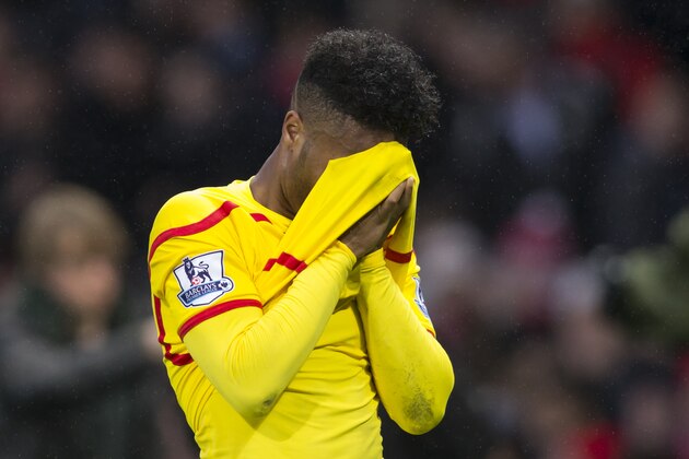 Liverpool's Raheem Sterling covers his face as he walks from the pitch after his team's 3-0 loss during the English Premier League soccer match between Manchester United and Liverpool at Old Trafford Stadium, Manchester, England, Sunday Dec. 14, 2014. (AP Photo/Jon Super)