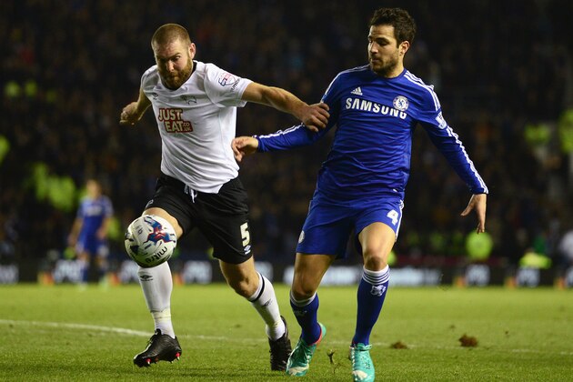 DERBY, ENGLAND - DECEMBER 16: Jake Buxton of Derby is challenged by Cesc Fabregas of Chelsea during the Capital One Cup Quarter-Final match between Derby County and Chelsea at Pride Park Stadium on December 16, 2014 in Derby, England.  (Photo by Jamie McDonald/Getty Images)