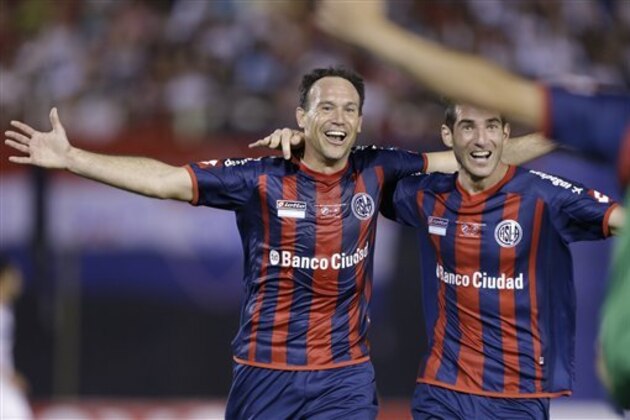 Mauro Matos of Argentina's San Lorenzo, left, celebrates with temamates Ignacio Piatti after scoring against Paraguay's Nacional during a Copa Libertadores final soccer match in Asuncion, Paraguay, Wednesday, Aug. 6, 2014. (AP Photo/Jorge Saenz)