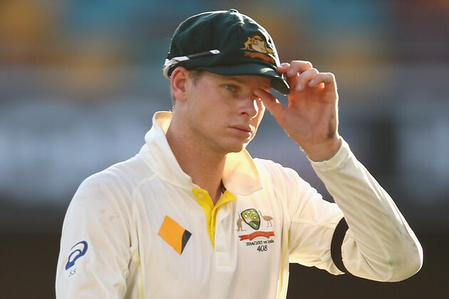 BRISBANE, AUSTRALIA - DECEMBER 17:  Australian captain Steve Smith leaves the field at the conclusion of play during day one of the 2nd Test match between Australia and India at The Gabba on December 17, 2014 in Brisbane, Australia.  (Photo by Cameron Spencer/Getty Images)
