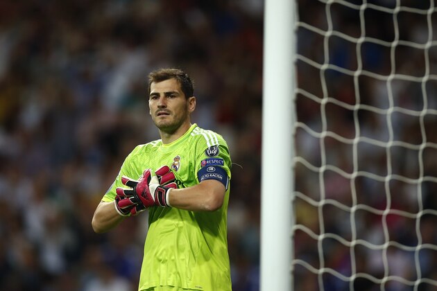 Real's Iker Casillas adjusts his gloves during the Champions League Group B soccer match between Real Madrid and Basel at the Santiago Bernabeu stadium in Madrid, Spain, Tuesday, Sept. 16, 2014. (AP Photo/Andres Kudacki)