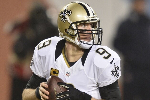 CHICAGO, IL - DECEMBER 15: Drew Brees #9 of the New Orleans Saints rolls out during the first quarter of a game against the Chicago Bears at Soldier Field on December 15, 2014 in Chicago, Illinois. (Photo by Brian Kersey/Getty Images)