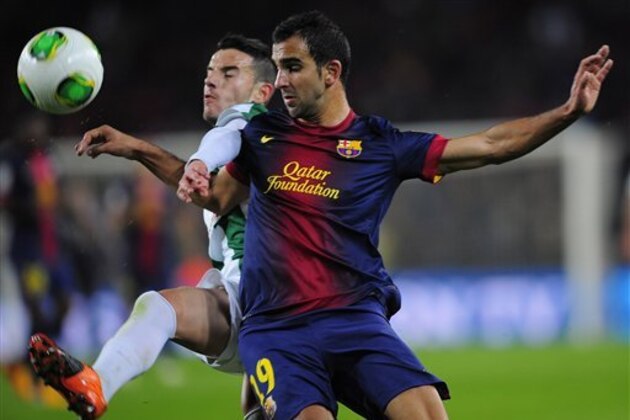 FC Barcelona's Martin Montoya, right, duels for the ball against Cordoba's Fernandez during a Copa del Rey soccer match at the Camp Nou stadium in Barcelona, Spain, Thursday, Jan. 10, 2013. (AP Photo/Manu Fernandez)