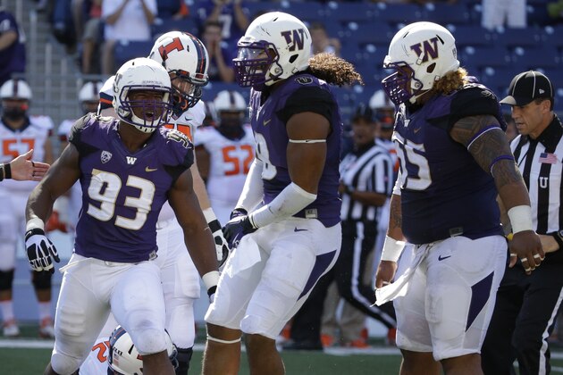 Washington's (from left) Andrew Hudson, Hau'oli Kikaha, and Danny Shelton celebrate a sack by Hudson against Illinois in an NCAA college football game Saturday, Sept. 13, 2014, in Seattle. (AP Photo/Ted S. Warren)