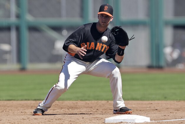 San Francisco Giants' Buster Posey playing first base against Japan during an exhibition spring training baseball game on Thursday, March 14, 2013 in Scottsdale, Ariz. (AP Photo/Marcio Jose Sanchez)