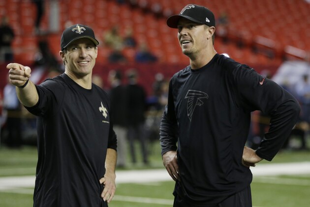 New Orleans Saints quarterback Drew Brees, left, speaks with Atlanta Falcons quarterback Matt Ryan before the first half of an NFL football game, Thursday, Nov. 21, 2013, in Atlanta. (AP Photo/John Bazemore)