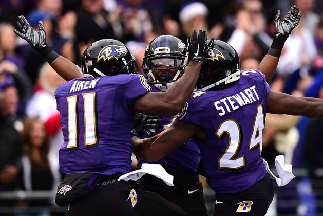 BALTIMORE, MD - DECEMBER 14: Wide receiver Kamar Aiken #11 of the Baltimore Ravens celebrates with free safety Darian Stewart #24 and linebacker Zach Orr #54 after scoring a first quarter touchdown off a blocked punt against the Jacksonville Jaguars at M&T Bank Stadium on December 14, 2014 in Baltimore, Maryland. (Photo by Patrick Smith/Getty Images)