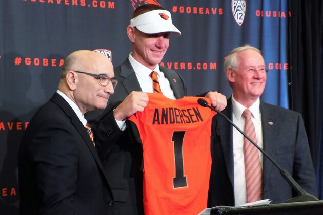 Oregon State new football coach, Gary Andersen, center, poses with Oregon State athletic director, Bob De Carolis, left, and Oregon State University president, Edward Ray, at a news conference in Corvallis, Oregon, on Dec. 12, 2014. Andersen comes to the Beavers after two seasons as head coach at Wisconsin. (AP Photo/Anne Peteson)