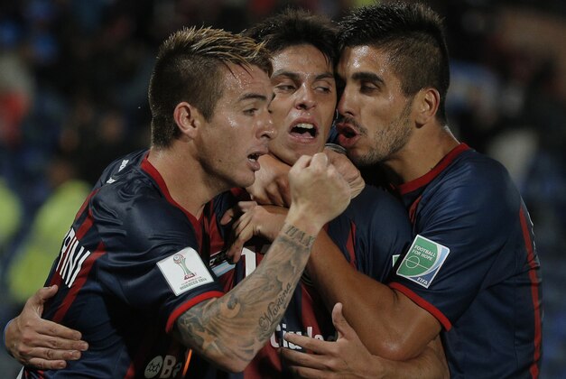 San Lorenzo's Pablo Barrientos, center, celebrates with teammates after scoring during the semi final soccer match between Auckland City FC and San Lorenzo at the Club World Cup soccer tournament in Marrakech, Morocco, Wednesday, Dec. 17, 2014. (AP Photo/Christophe Ena)