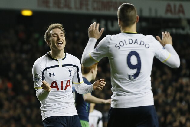 Tottenham’s Christian Eriksen, left, congratulates Roberto Soldado after he scored his side's fourth goal during their English League Cup soccer quarterfinal match between Tottenham Hotspur and Newcastle United at White Hart Lane stadium in London Wednesday, Dec. 17,  2014. (AP Photo/Alastair Grant)