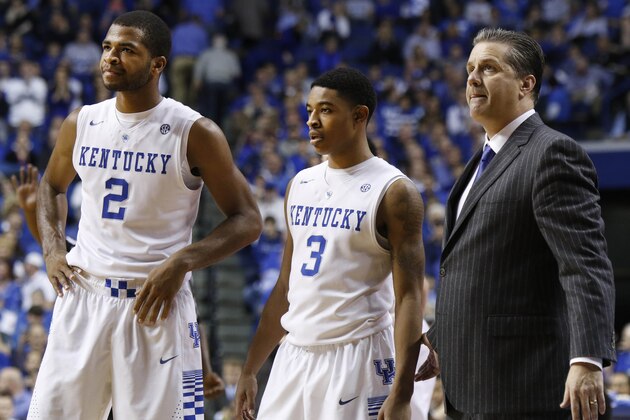 From left, Kentucky's Aaron Harrison, Tyler Ulis, and head coach John Calipari pause for a moment during the second half of an NCAA college basketball game, Saturday, Dec. 13, 2014. Kentucky won 84-70. (AP Photo/James Crisp)