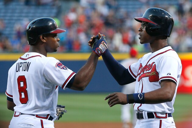 ATLANTA, GA - APRIL 25:  Justin Upton #8 of the Atlanta Braves celebrates his three-run homer against the Cincinnati Reds in the first inning with B.J. Upton #2 at Turner Field on April 25, 2014 in Atlanta, Georgia.  (Photo by Kevin C. Cox/Getty Images)