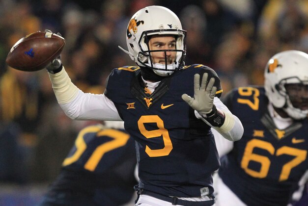 West Virginia quarterback Clint Trickett (9) attempts a pass during the first half of an NCAA college football game against Kansas State in Morgantown, W.Va., on Thursday, Nov. 20, 2014. (AP Photo/Chris Jackson)