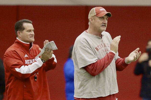 Nebraska interim head coach Barney Cotton, right, and offensive coordinator Tim Beck clap their hands during practice in Lincoln, Neb., Wednesday, Dec. 10, 2014. Nebraska begins practicing for the NCAA college football Holiday Bowl against USC with interim coach Barney Cotton in charge. Bo Pelini was fired 10 days ago, and new coach Mike Riley is busy recruiting players and assembling his staff. (AP Photo/Nati Harnik)