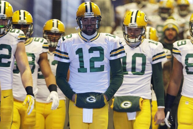 Green Bay Packers quarterback Aaron Rodgers (12) leads teammates toward the field at Ralph Wilson Stadium to warm up before an NFL football game against the Buffalo Bills Sunday, Dec. 14, 2014, in Orchard Park, N.Y.  (AP Photo/Bill Wippert)
