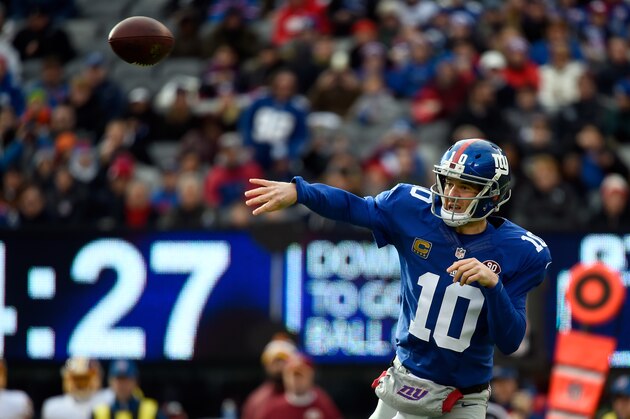 EAST RUTHERFORD, NJ - DECEMBER 14:  Eli Manning #10 of the New York Giants looks to throw a pass in the first half against the Washington Redskins during their game at MetLife Stadium on December 14, 2014 in East Rutherford, New Jersey.  (Photo by Alex Goodlett/Getty Images)
