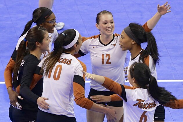 Texas players including Haley Eckerman (10), Hannah Allison (12) and Kat Brooks (6) celebrate with teammates after the team's win over American in the semifinals of an NCAA college volleyball regional tournament in Lincoln, Neb., Friday, Dec. 13, 2013. (AP Photo/Nati Harnik)
