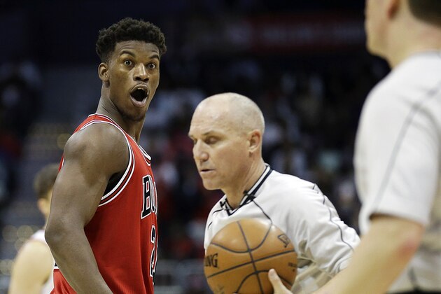 Chicago Bulls' Jimmy Butler, left, reacts while arguing with referee Nick Burchert, right, in the fourth quarter of an NBA basketball game against the Atlanta Hawks, Monday, Dec. 15, 2014, in Atlanta. Atlanta won 93-86. (AP Photo/David Goldman)