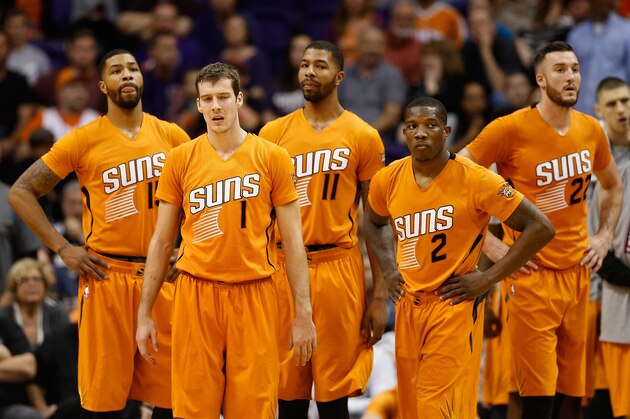 PHOENIX, AZ - NOVEMBER 07:  (L-R) Marcus Morris #15, Goran Dragic #1, Markieff Morris #11, Eric Bledsoe #2 and Miles Plumlee #22 of the Phoenix Suns wait for the start of overtime during the NBA game against the Sacramento Kings at US Airways Center on November 7, 2014 in Phoenix, Arizona. The Kings defeated the Suns 114-112 in double overtime. NOTE TO USER: User expressly acknowledges and agrees that, by downloading and or using this photograph, User is consenting to the terms and conditions of the Getty Images License Agreement.  (Photo by Christian Petersen/Getty Images)