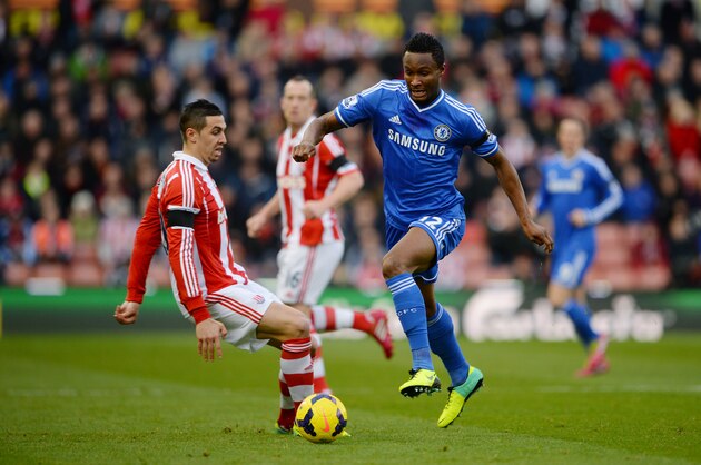STOKE ON TRENT, ENGLAND - DECEMBER 07:  John Obi Mikel of Chelsea goes past Geoff Cameron of Stoke during the Barclays Premier League match between Stoke City and Chelsea at Britannia Stadium on December 7, 2013 in Stoke on Trent, England.  (Photo by Michael Regan/Getty Images)