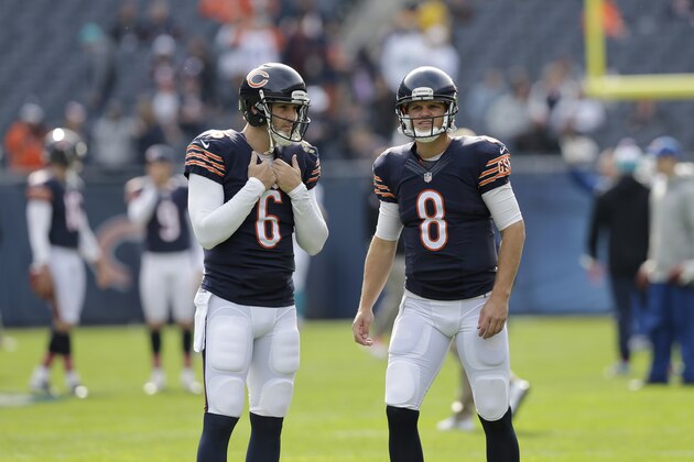 Chicago Bears quarterback Jay Cutler (6) talks to  backup quarterback Jimmy Clausen (8) before an NFL football game Sunday, Oct. 19, 2014 in Chicago. (AP Photo/Nam Y. Huh)