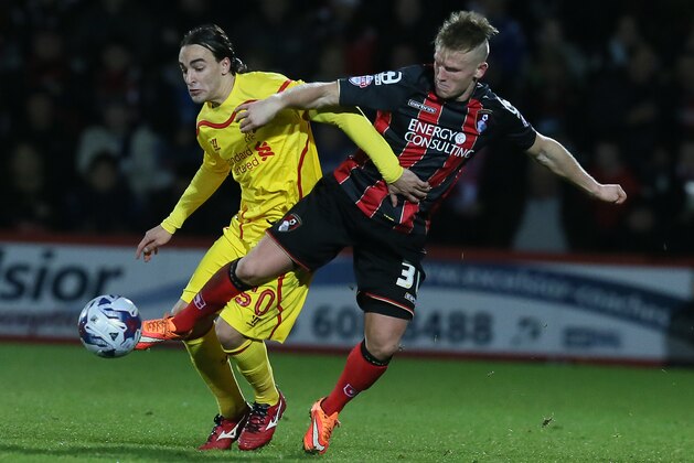 Liverpool’s Lazar Markovic, left, and Bournemouth’s Matt Ritchie compete for the ball during the English League Cup soccer quarterfinal match between AFC Bournemouth and Liverpool at Goldsands Stadium, Bournemouth, England, Wednesday, Dec. 17, 2014. (AP Photo/Tim Ireland)
