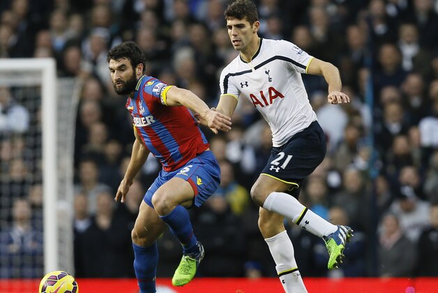 Tottenham's Federico Fazio, right, competes for the ball with Crystal Palace's Mile Jedinak  during the English Premier League soccer match between Tottenham Hotspur and Crystal Palace at White Hart Lane stadium in London, Saturday, Dec. 6, 2014. (AP Photo/Kirsty Wigglesworth)