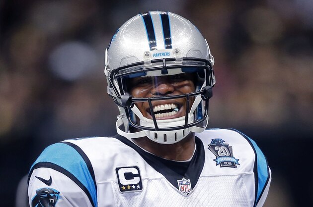 Carolina Panthers quarterback Cam Newton (1) laughs as he carries for a first down in the first half of an NFL football game against the New Orleans Saints in New Orleans, Sunday, Dec. 7, 2014. (AP Photo/Bill Haber)