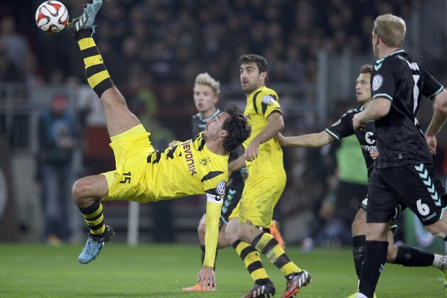 Dortmund's Mats Hummels fails to score during the German soccer cup second round match between FC St. Pauli and Borussia Dortmund at the Millerntor Stadium in Hamburg, Germany, Tuesday, Oct. 28, 2014. (AP Photo/Michael Sohn)