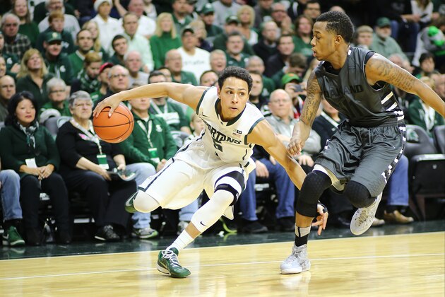 EAST LANSING, MI - DECEMBER 14:  Bryn Forbes #5 of the Michigan State Spartans drives to the basket against Nick Daniels #11 of the Oakland Golden Grizzlies at the Breslin Center on December 14, 2014 in East Lansing, Michigan. (Photo by Rey Del Rio/Getty Images)