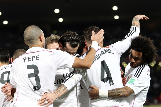 Real Madrid’s Sergio Ramos, second right, celebrates with teammates his opening goal during the semi final soccer match between Real Madrid and Cruz Azul at the Club World Cup soccer tournament in Marrakech, Morocco, Tuesday, Dec. 16, 2014. (AP Photo/Abdeljalil Bounhar)