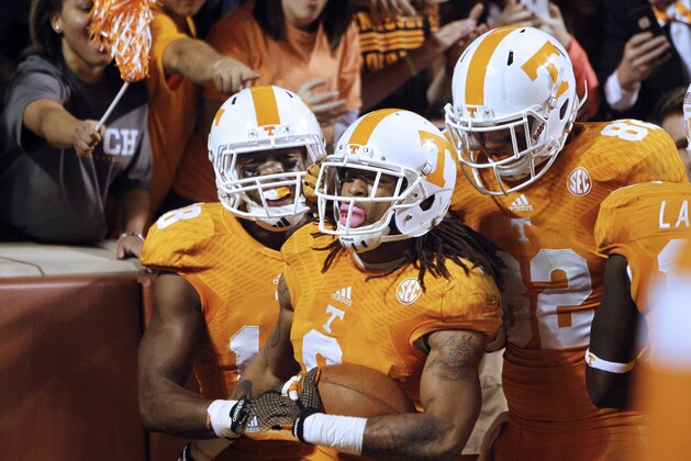 Tennessee wide receiver Von Pearson (9) is congratulated by teammates Ethan Wolf (82) and Jason Croom (18) in the third quarter of an NCAA college football game against Alabama on Saturday, Oct. 25, 2014 in Knoxville, Tenn. Alabama won 34-20. (AP Photo/Wade Payne)