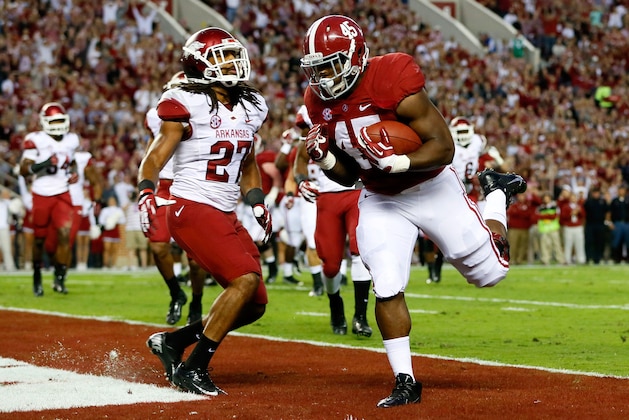 TUSCALOOSA, AL - OCTOBER 19:  Jalston Fowler #45 of the Alabama Crimson Tide scores a touchdown past Alan Turner #27 of the Arkansas Razorbacks at Bryant-Denny Stadium on October 19, 2013 in Tuscaloosa, Alabama.  (Photo by Kevin C. Cox/Getty Images)