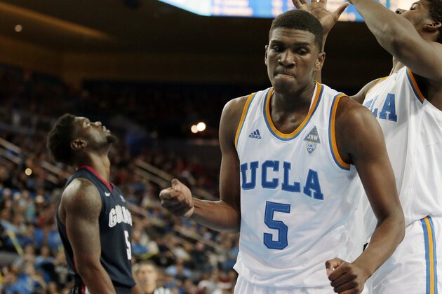 UCLA forward Kevon Looney, right, celebrates a basket as Gonzaga guard Gary Bell Jr. watches the replay during the second half of an NCAA college basketball game in Los Angeles, Saturday, Dec. 13, 2014. Gonzaga won 87-74. (AP Photo/Chris Carlson)