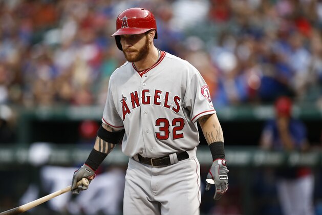 Los Angeles Angels' Josh Hamilton (32) reacts after striking out against the Texas Rangers during the fourth inning of a baseball game, Saturday, Aug. 16, 2014, in Arlington, Texas. (AP Photo/Jim Cowsert)