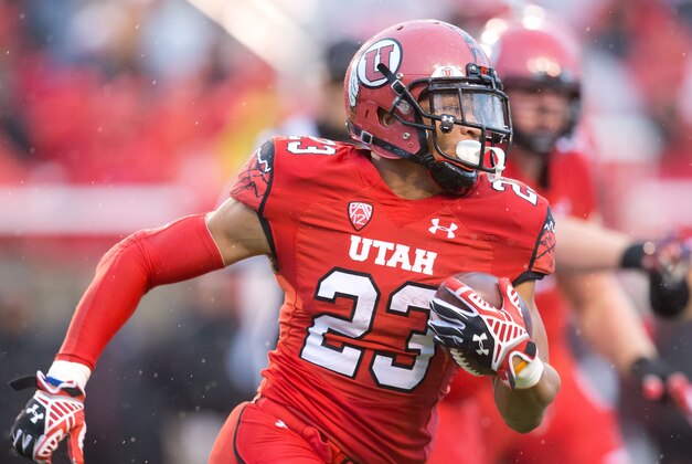 Nov 22, 2014; Salt Lake City, UT, USA; Utah Utes running back Devontae Booker (23) runs with the ball during the first half against the Arizona Wildcats at Rice-Eccles Stadium. Mandatory Credit: Russ Isabella-USA TODAY Sports