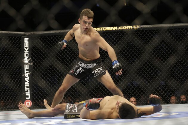 Myles Jury, top, prepares to punch Ramsey Nijem during the second round of a UFC lightweight mixed martial arts fight in San Jose, Calif., Saturday, April 20, 2013. Jury won by knock out in the second round. (AP Photo/Jeff Chiu)