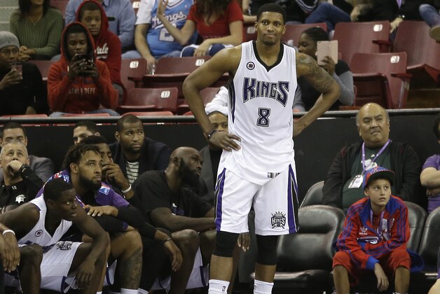 Sacramento Kings forward Rudy Gay, standing, watches, from the sidelines, during the closing moments of the Kings 95-90 loss to the Detroit Pistons during  an NBA basketball game in Sacramento, Calif., Saturday, Dec. 13, 2014.(AP Photo/Rich Pedroncelli)