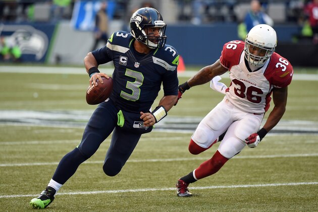 SEATTLE, WA - NOVEMBER 23:  Russell Wilson #3 of the Seattle Seahawks runs the ball out of the pocket in the third quarter against  Deone Bucannon #36 of the Arizona Cardinals during their game at CenturyLink Field on November 23, 2014 in Seattle, Washington.  (Photo by Steve Dykes/Getty Images)