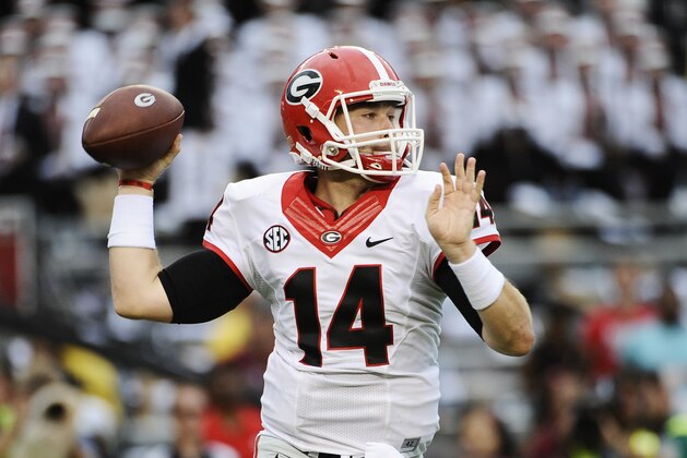 Georgia quarterback Hutson Mason (14) looks to pass against South Carolina during the first half of an NCAA college football game on Saturday, Sept. 13, 2014, in Columbia, S.C. (AP Photo/Rainier Ehrhardt)