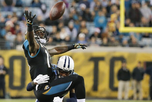 Tennessee Titans cornerback Coty Sensabaugh breaks up a pass intended for Jacksonville Jaguars wide receiver Marqise Lee (11) during the first half of an NFL football game in Jacksonville, Fla., Thursday, Dec. 18, 2014. (AP Photo/Stephen B. Morton)
