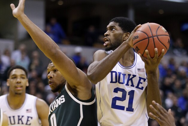 Duke's Amile Jefferson (21) goes to the basket against Michigan State's Marvin Clark Jr. (0) during the second half of an NCAA college basketball game Tuesday, Nov. 18, 2014, in Indianapolis. Duke won 81-71. (AP Photo/Darron Cummings)