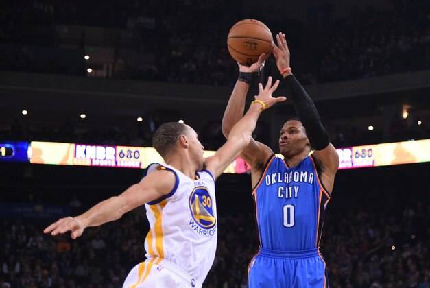 December 18, 2014; Oakland, CA, USA; Oklahoma City Thunder guard Russell Westbrook (0) shoots the basketballl against Golden State Warriors guard Stephen Curry (30) during the first quarter at Oracle Arena. Mandatory Credit: Kyle Terada-USA TODAY Sports