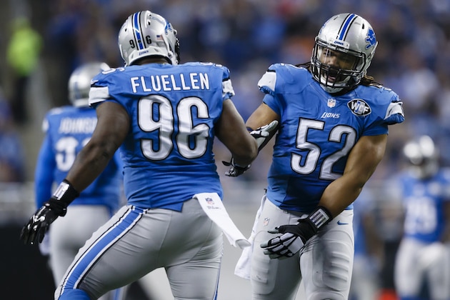 Detroit Lions defensive tackle Andre Fluellen, left, and defensive end Darryl Tapp (52) react after their sack of Minnesota Vikings quarterback Teddy Bridgewater during the first half of an NFL football game at Ford Field in Detroit, Sunday, Dec. 14, 2014. (AP Photo/Rick Osentoski)